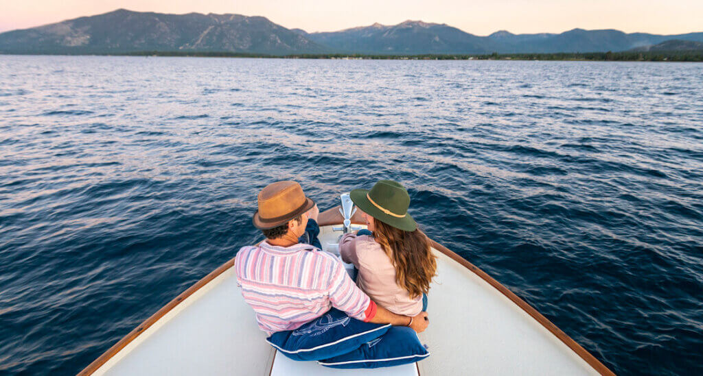 Couple on cruise enjoying Lake Tahoe sunset