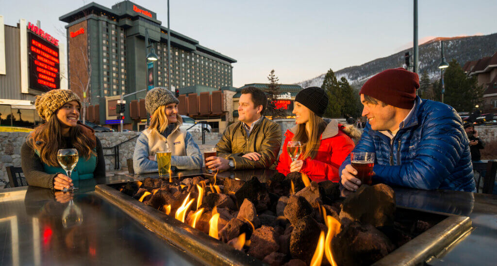 Friends enjoying apres drinks by a firepit at Stateline