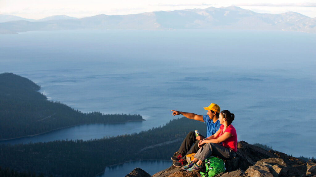 A couple looking at the view from top of Mt Tallac